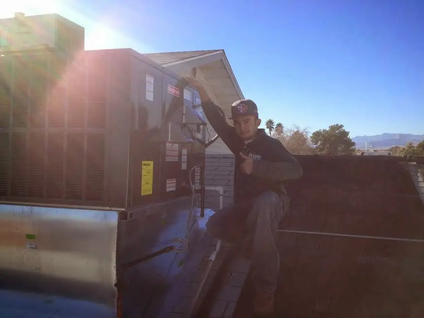 HVAC technician performing HVAC Inspection on a rooftop unit in Smyrna
